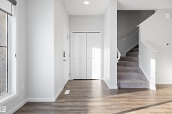 Foyer entrance with stairs, light wood-type flooring, and recessed lighting - 