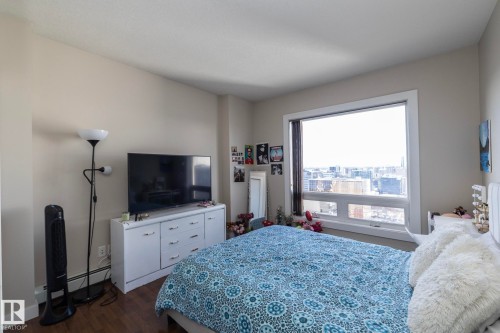 Bedroom with dark wood finished floors and baseboard heating - 2005 10136 104 Street, Edmonton, AB - Indoor Photo Showing Bedroom