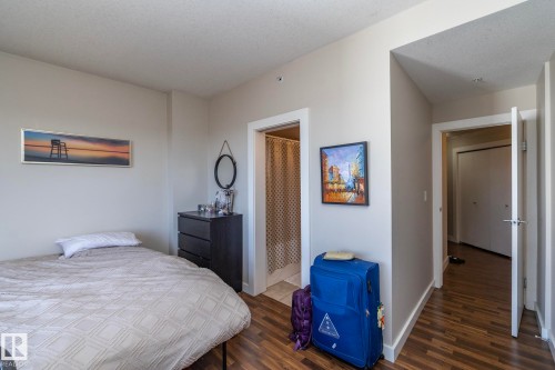 Bedroom with dark wood finished floors - 2005 10136 104 Street, Edmonton, AB - Indoor Photo Showing Bedroom
