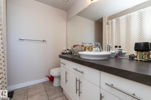 Full bath featuring vanity, light tile patterned floors, and a shower with curtain - 2005 10136 104 Street, Edmonton, AB - Indoor Photo Showing Bathroom