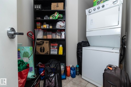 Laundry area with stacked washer / drying machine - 2005 10136 104 Street, Edmonton, AB - Indoor Photo Showing Laundry Room