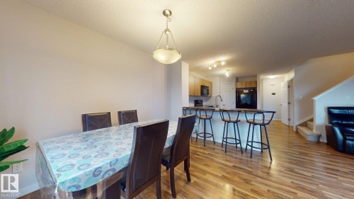 Dining room featuring light wood-style flooring and a textured ceiling - 1030 177A Street, Edmonton, AB - Indoor Photo Showing Dining Room