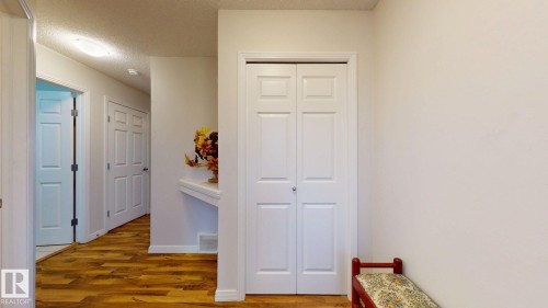 Corridor featuring a textured ceiling and wood finished floors - 1030 177A Street, Edmonton, AB - Indoor Photo Showing Other Room