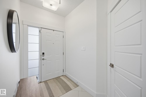 Foyer entrance featuring baseboards and light tile patterned flooring - 30 Willow Link, Fort Saskatchewan, AB - Indoor Photo Showing Other Room