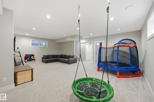 Recreation room with light carpet and recessed lighting - 30 Willow Link, Fort Saskatchewan, AB - Indoor