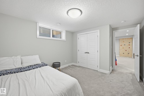 Bedroom with light carpet, a textured ceiling, and a closet - 30 Willow Link, Fort Saskatchewan, AB - Indoor Photo Showing Bedroom