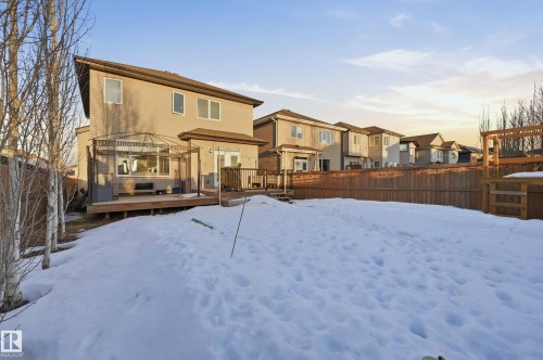 Snow covered rear of property with a residential view, a deck, and a fenced backyard - 30 Willow Link, Fort Saskatchewan, AB - Outdoor With Deck Patio Veranda