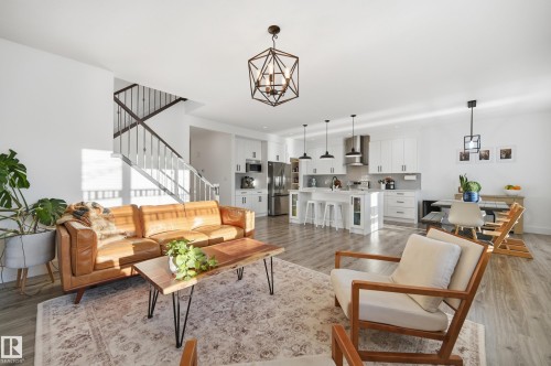 Living area featuring suspended lighting and light wood-style flooring - 30 Willow Link, Fort Saskatchewan, AB - Indoor Photo Showing Living Room