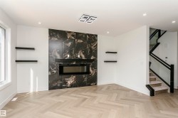 Unfurnished living room with parquet flooring, a fireplace, recessed lighting, and plenty of natural light - 