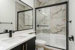 Full bath with vanity and a marble finish shower - 
