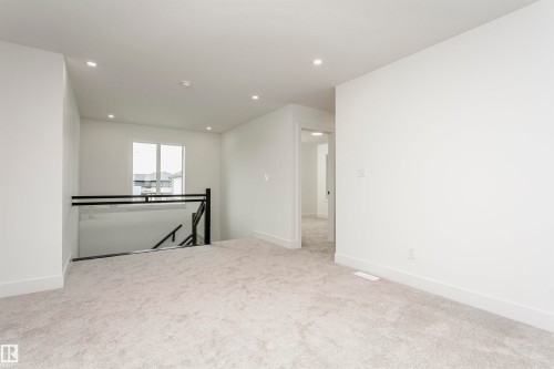 Spare room featuring light colored carpet and recessed lighting - 3248 Pelerin Crescent, Beaumont, AB - Indoor Photo Showing Other Room