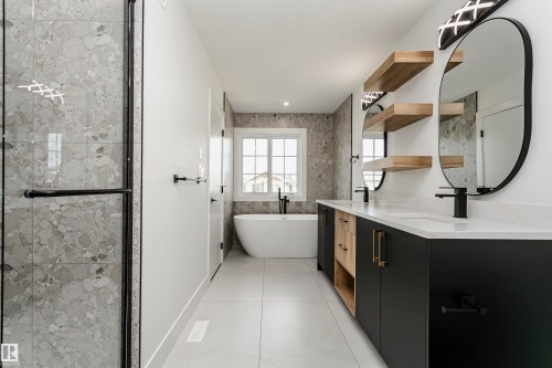 Bathroom with a freestanding tub, double vanity, a stall shower, and light tile patterned flooring - 3248 Pelerin Crescent, Beaumont, AB - Indoor Photo Showing Bathroom