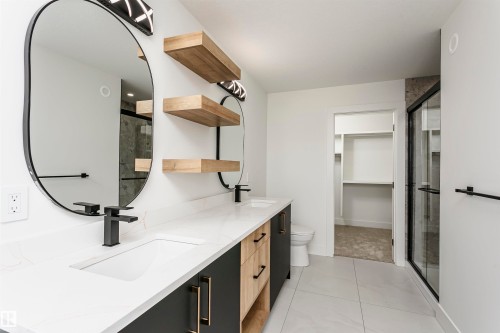 Full bathroom featuring a shower stall, double vanity, a walk in closet, and light tile patterned flooring - 3248 Pelerin Crescent, Beaumont, AB - Indoor