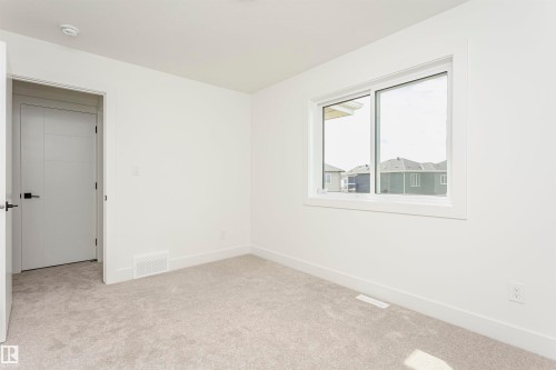 Unfurnished bedroom with light carpet and baseboards - 3248 Pelerin Crescent, Beaumont, AB - Indoor Photo Showing Other Room