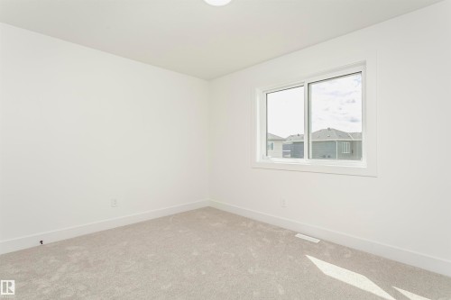 Empty room with baseboards and carpet flooring - 3248 Pelerin Crescent, Beaumont, AB - Indoor Photo Showing Other Room
