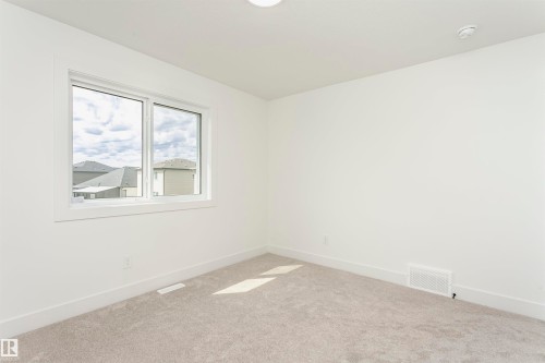 Carpeted empty room featuring baseboards - 3248 Pelerin Crescent, Beaumont, AB - Indoor Photo Showing Other Room