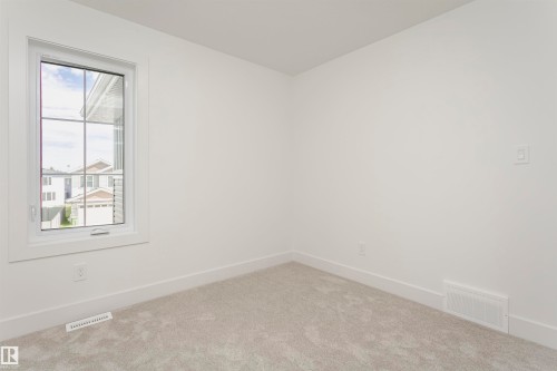Carpeted spare room with baseboards - 3248 Pelerin Crescent, Beaumont, AB - Indoor Photo Showing Other Room