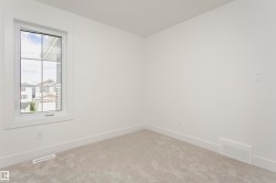 Carpeted spare room with baseboards - 