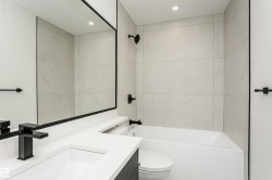 Bathroom with vanity, bathtub / shower combination, and recessed lighting - 