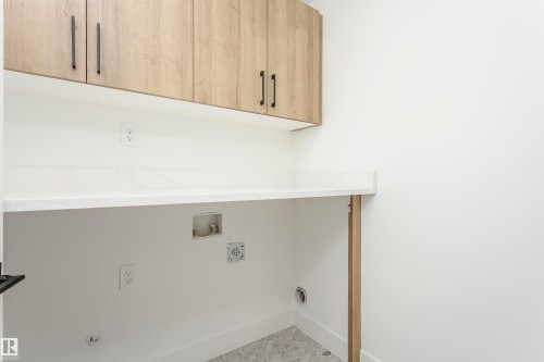 Laundry room featuring washer hookup and cabinet space - 3248 Pelerin Crescent, Beaumont, AB - Indoor Photo Showing Other Room