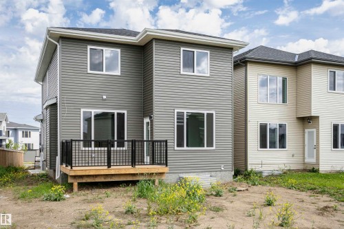 Rear view of property featuring a wooden deck - 3248 Pelerin Crescent, Beaumont, AB - Outdoor With Deck Patio Veranda