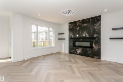Unfurnished living room with a premium fireplace, parquet floors, and recessed lighting - 