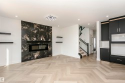 Unfurnished living room featuring parquet floors, recessed lighting, and a fireplace - 