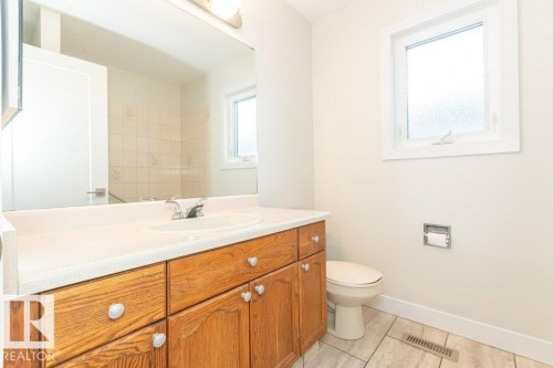 Bathroom featuring vanity and light tile patterned floors - 5720 109A Street Nw, Edmonton, AB - Indoor Photo Showing Bathroom