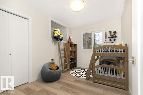 Bedroom featuring light wood-type flooring, a closet, and a textured ceiling - 5720 109A Street Nw, Edmonton, AB - Indoor