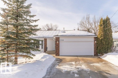 View of front facade with brick siding, driveway, and an attached garage - 5720 109A Street Nw, Edmonton, AB - Outdoor