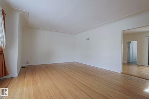 Unfurnished room with light wood-style floors and baseboards - 11507 72 Avenue Nw, Edmonton, AB - Indoor Photo Showing Other Room