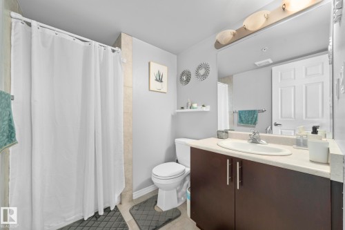 Bathroom featuring a shower stall, vanity, and light tile patterned floors - 301 10118 106 Avenue, Edmonton, AB - Indoor Photo Showing Bathroom