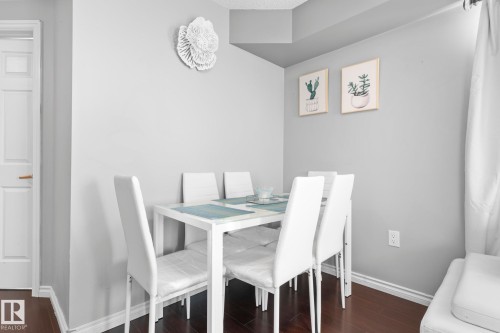 Dining space with baseboards and dark wood finished floors - 301 10118 106 Avenue, Edmonton, AB - Indoor Photo Showing Dining Room