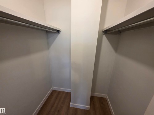 Walk in closet featuring dark wood-style floors - Edmonton, AB - Indoor With Storage