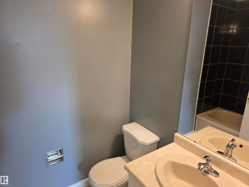 Bathroom featuring vanity and shower / washtub combination - Edmonton, AB - Indoor Photo Showing Bathroom