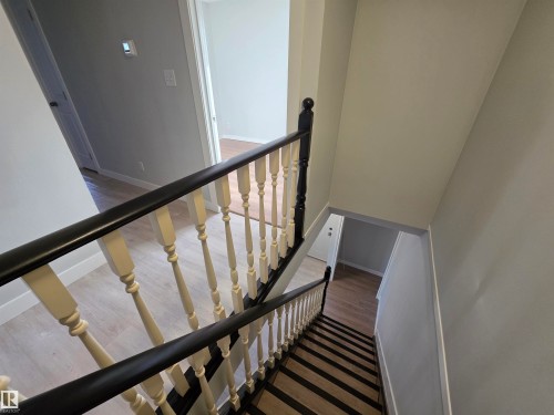Stairway with wood finished floors and baseboards - Edmonton, AB - Indoor Photo Showing Other Room