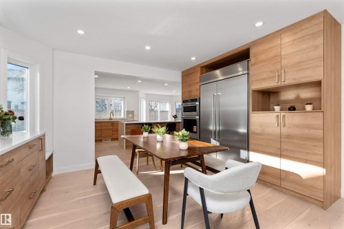 Kitchen featuring modern cabinets, open shelves, light wood-style flooring, stainless steel appliances, and recessed lighting - 607 Butterworth Wynd, Edmonton, AB - Indoor Photo Showing Dining Room