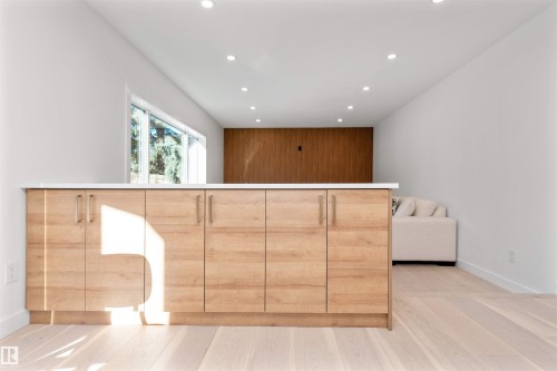 Interior space with recessed lighting, light wood-type flooring, and modern cabinets - 607 Butterworth Wynd, Edmonton, AB - Indoor Photo Showing Other Room