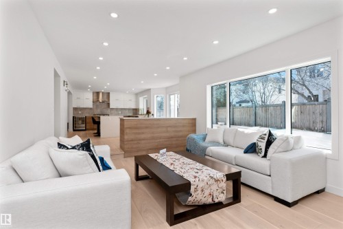 Living area featuring recessed lighting, light wood-style flooring, and wine cooler - 607 Butterworth Wynd, Edmonton, AB - Indoor Photo Showing Living Room