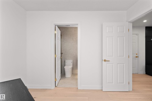 Unfurnished bedroom with light wood-style floors and ensuite bath - 607 Butterworth Wynd, Edmonton, AB - Indoor