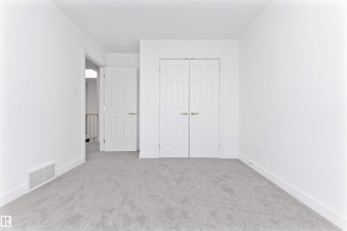 Unfurnished bedroom featuring carpet flooring and a closet - 607 Butterworth Wynd, Edmonton, AB - Indoor Photo Showing Other Room