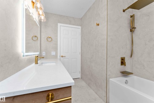 Bathroom with shower / bath combination, vanity, and a textured wall - 607 Butterworth Wynd, Edmonton, AB - Indoor Photo Showing Bathroom