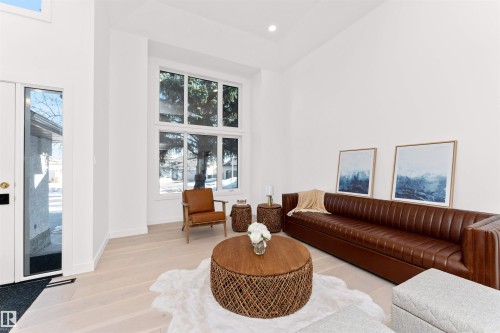 Living room featuring a high ceiling, light wood-style flooring, and recessed lighting - 607 Butterworth Wynd, Edmonton, AB - Indoor Photo Showing Living Room