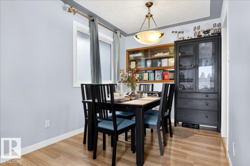 Dining room with a textured ceiling and light wood-style floors - 13320 123 Street, Edmonton, AB - Indoor Photo Showing Dining Room