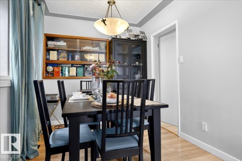 Dining area featuring light wood finished floors and a textured ceiling - 13320 123 Street, Edmonton, AB - Indoor Photo Showing Dining Room