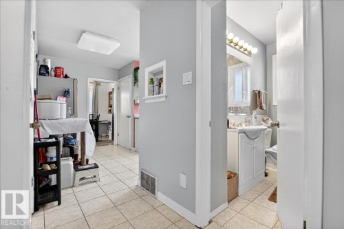Corridor featuring light tile patterned flooring and a sink - 13320 123 Street, Edmonton, AB - Indoor Photo Showing Other Room