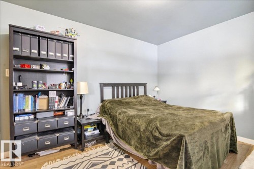 Bedroom featuring light wood-style floors and baseboards - 13320 123 Street, Edmonton, AB - Indoor Photo Showing Bedroom