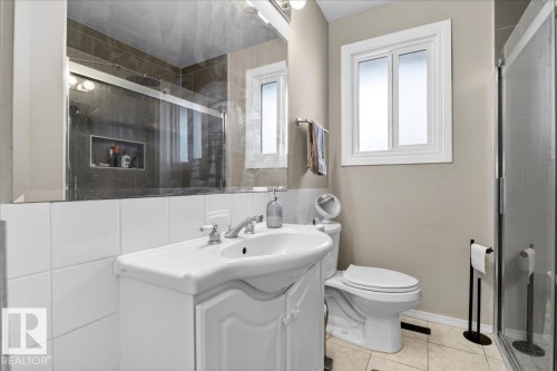 Full bathroom featuring vanity, a stall shower, and light tile patterned floors - 13320 123 Street, Edmonton, AB - Indoor Photo Showing Bathroom
