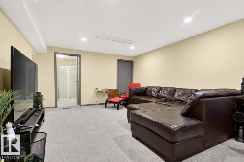 Living area featuring light colored carpet and recessed lighting - 13320 123 Street, Edmonton, AB - Indoor Photo Showing Other Room