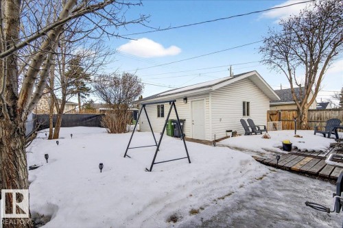 Snow covered back of property with a fenced backyard and an outdoor structure - 13320 123 Street, Edmonton, AB - Outdoor With Deck Patio Veranda